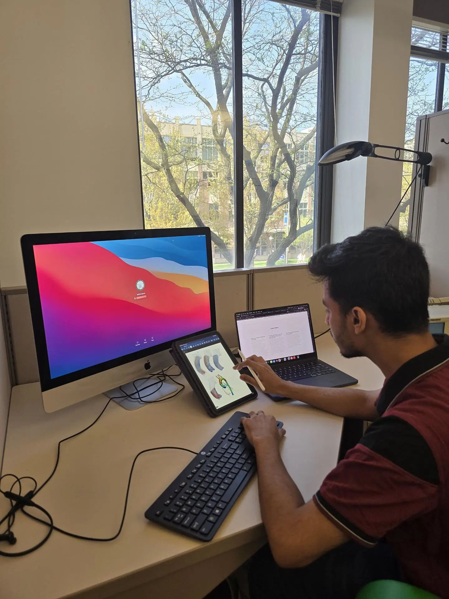 Research workstation with a desktop computer, laptop, and tablet